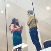 Two professionals engaged in conversation inside a modern Mediclinic facility.