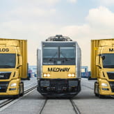A MEDWAY freight train with two Medlog trucks, highlighting the integrated logistics and transportation services of the MEDWAY brand.