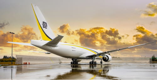 An MSC-branded cargo airplane parked on a wet tarmac, reflecting MSC's air freight capabilities and logistics services.
