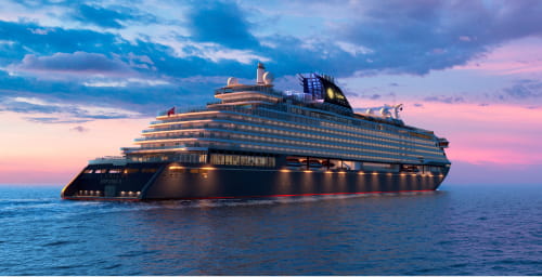 An Explora Journeys cruise ship sailing at sunset.