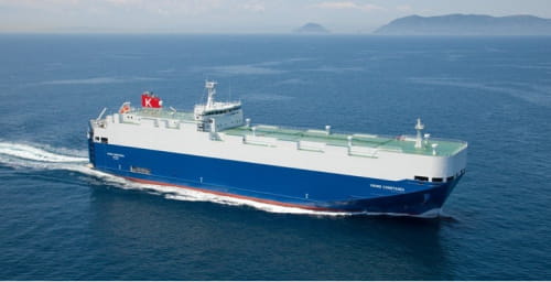 A Global Car Carriers (GCC) cargo ship sailing through open waters.