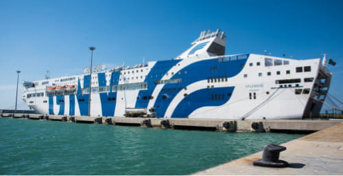 A GNV (Grandi Navi Veloci) passenger ferry docked at a port.